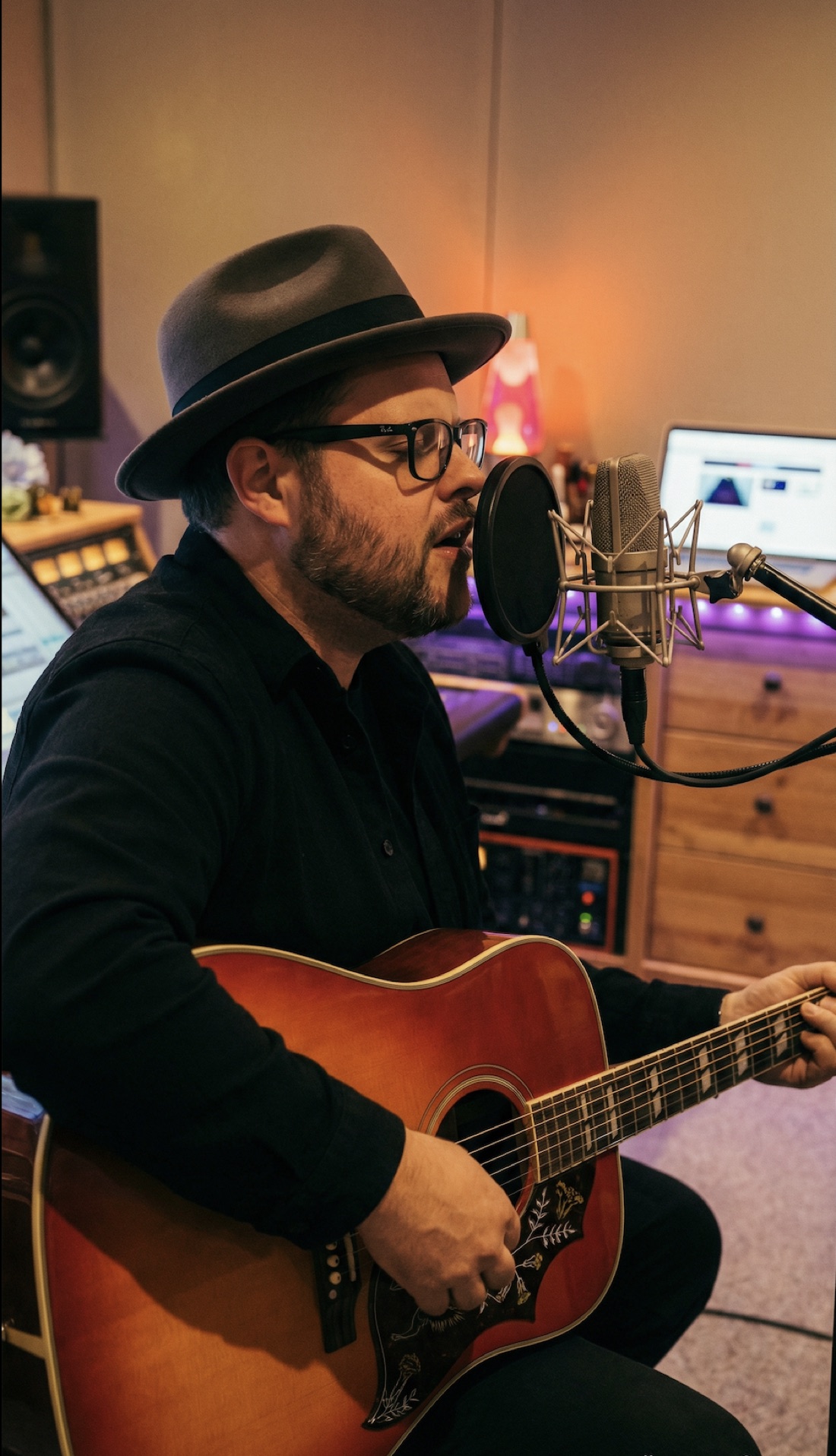 Grant Morriss writing and recording with an acoustic guitar